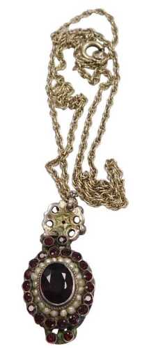 A garnet pendant and chain, the border and pendant mount set with garnet and a rim of seed...