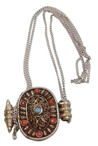 A Middle Eastern pendant and chain, the oval pendant set with coral and turquoise and filigree...
