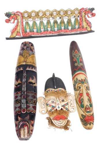 A group of carved and painted Middle Eastern touristwares, to include masks, figures in a dragon...