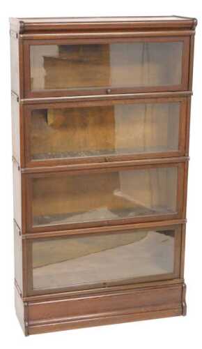A Globe Wernicke style oak four section bookcase, with four sliding glazed doors, on a plinth,...