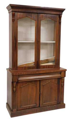 A Victorian mahogany bookcase, the top with a moulded edge above two glass fronted doors...
