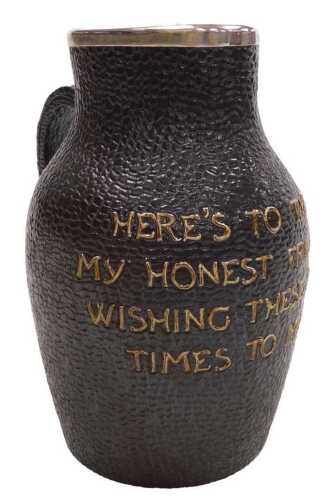 A Doulton Lambeth stoneware leather jug, with a silver mount, to tube line decorated "Here's to...