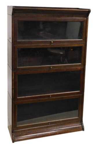 A Globe Wernicke style oak four section bookcase, with sliding doors, raised on a moulded base,...
