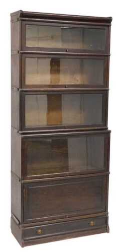 A Globe Wernicke style oak sectional bookcase, with four sliding glass doors above a sliding...