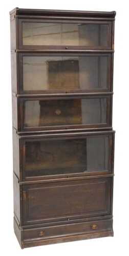 A Globe Wernicke oak sectional bookcase, the top with four sliding graduated glass doors above...