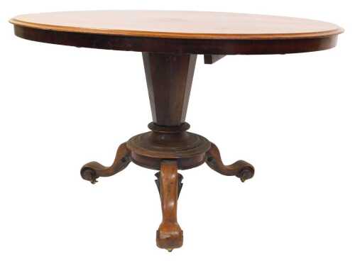 A Victorian mahogany tilt top table, the oval top with a moulded edge, on a tapering column...