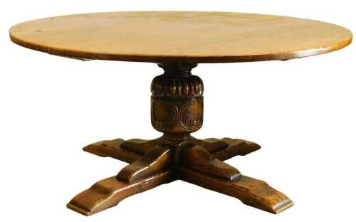 A 20thC oak dining table, the circular top on a carved and part fluted column, raised on an X...