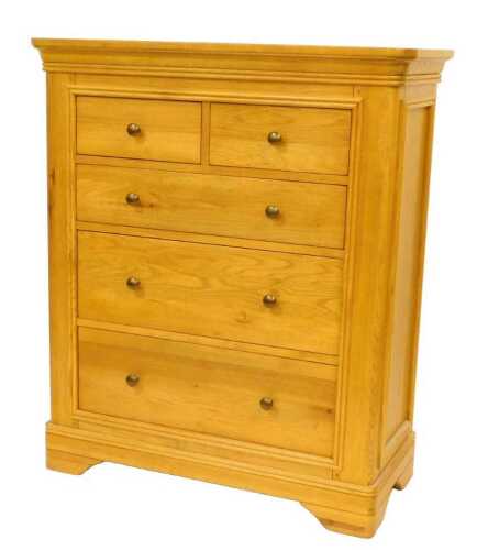 A contemporary oak chest of drawers, the top with a rounded edge above four graduated drawers,...