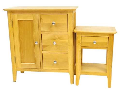 A contemporary oak side cabinet, the top with a rounded edge above a panelled door flanked by...