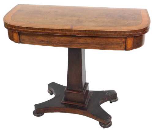 A George III rosewood and satinwood cross banded demi lune fold over card table, with a baize...