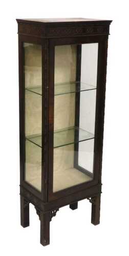 An Edwardian mahogany display cabinet, with blind fret frieze, single drawer and square legs,...