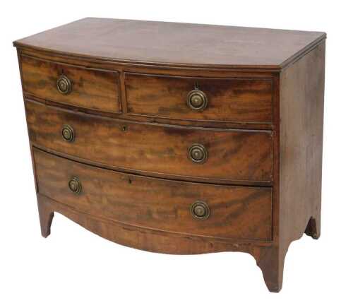 A George III mahogany bow front chest, of two short and two graduated drawers, with brass...