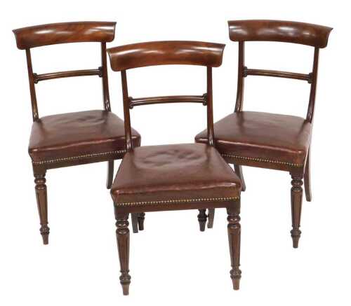 A set of three William IV bar back dining chairs, with studded overstuffed leather seats and...