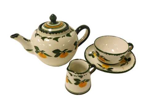 A Perret-Gentil of Merton miniature pottery teapot, decorated with oranges, a cup and saucer and...