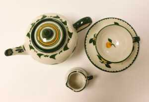 A Perret-Gentil of Merton miniature pottery teapot, decorated with oranges, a cup and saucer and... - 2