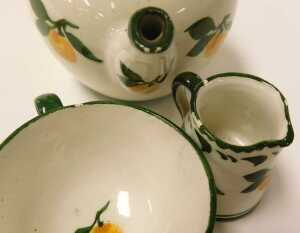 A Perret-Gentil of Merton miniature pottery teapot, decorated with oranges, a cup and saucer and... - 4