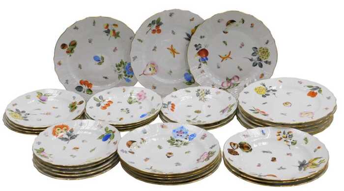 A 20thC Herend porcelain part dinner service, painted with fruit, nuts and floral sprigs, within...