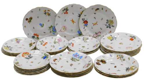 A 20thC Herend porcelain part dinner service, painted with fruit, nuts and floral sprigs, within...