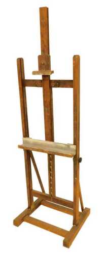 A stained pine artist's easel, with silver painted rest, 165cm high. VAT is payable on hammer...