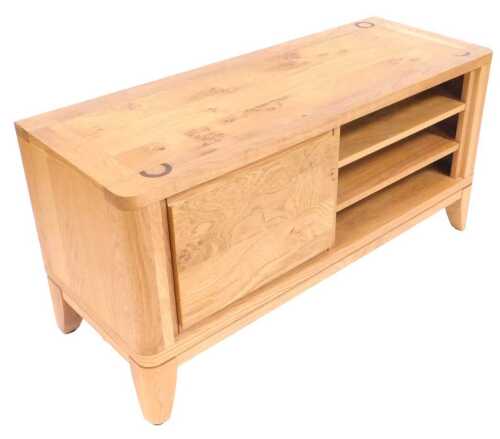 A light oak tv cabinet, with a door and three shelves on bracket feet, 52cm high, 105cm wide,...