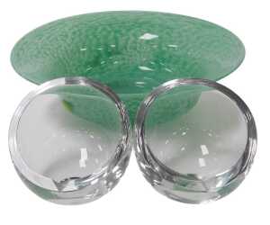 A 20thC green glass bowl, possibly Monart, 26cm wide, together with a pair of glass ashtrays, of...