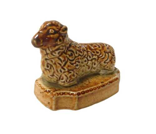 A 19thC stoneware sheep, on a rectangular base, with re-entrant corners, 7cm long. VAT is...