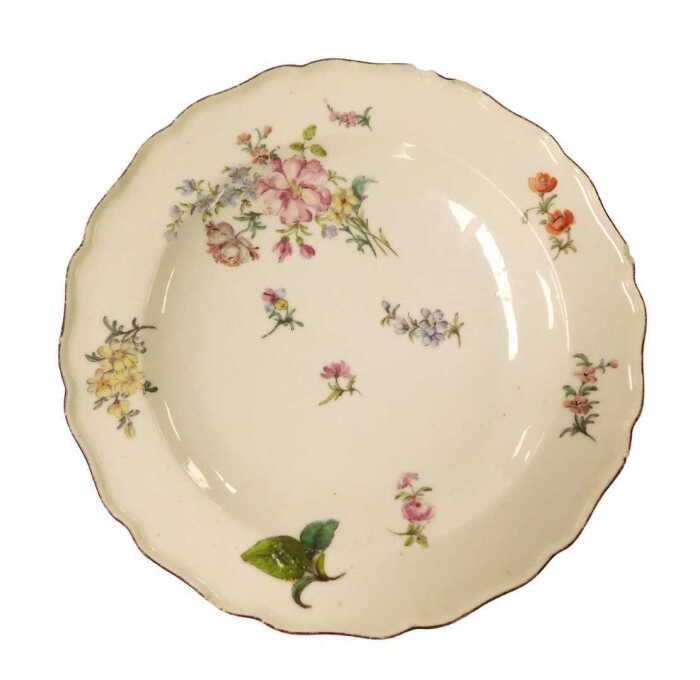 An 18thC Chelsea red anchor period plate, painted in Deutche Blumen floral sprays, mark to...