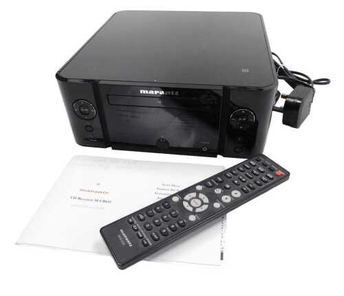 A Marantz CD receiver, M-CR611, with remote and set up guide.
