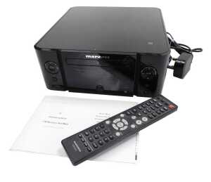 A Marantz CD receiver, M-CR611, with remote and set up guide.