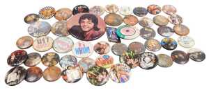 A collection of 1980s pop group badges, including The Police, Heaven 17, ACDC, Wham, Bow Wow Wow,...