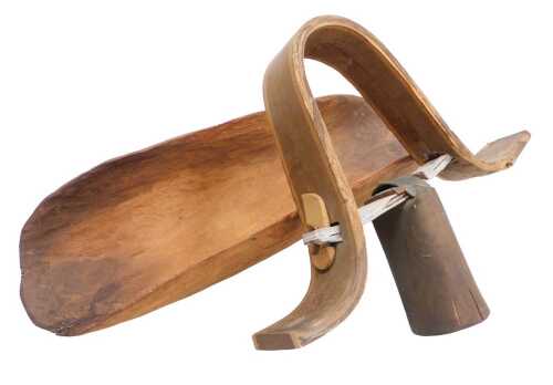 An Austrian cow bell, and a wooden carved bowl, possibly Australian Aboriginal, 47cm wide. (2)