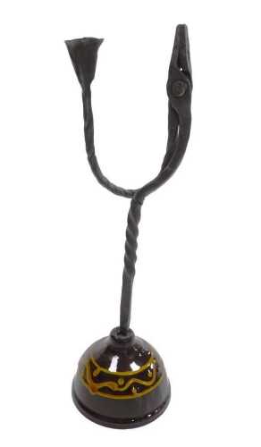 A late 18thC wrought iron rush light candle holder, raised on a brown domed slipware base, 36cm...