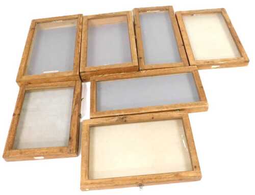 Five pine table top display cabinets, with Perspex and glass tops, the largest 72cm wide.