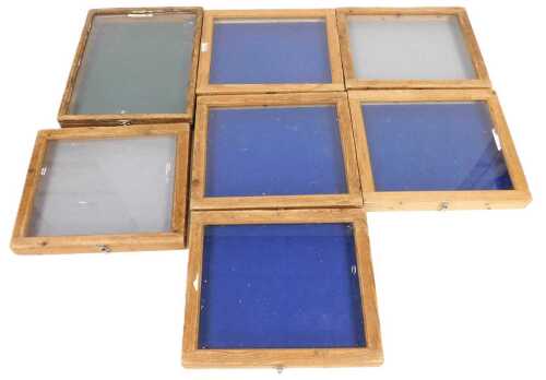 Seven pine framed table top display cases, with Perspex and glass tops, 61cm wide.