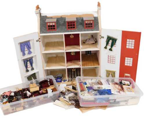 A three storey Georgian style doll's house, 110cm high, together with figures and furniture.