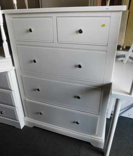 A modern white finished chest, of two short over three long drawers, raised on bracket feet,...