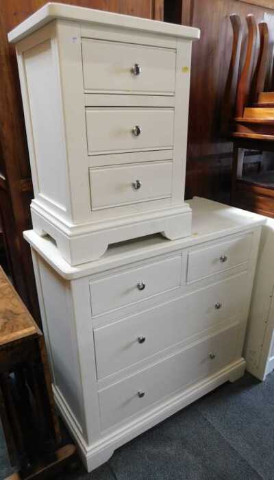 A small white finished chest of three drawers, on bracket feet, and a white finished chest of...