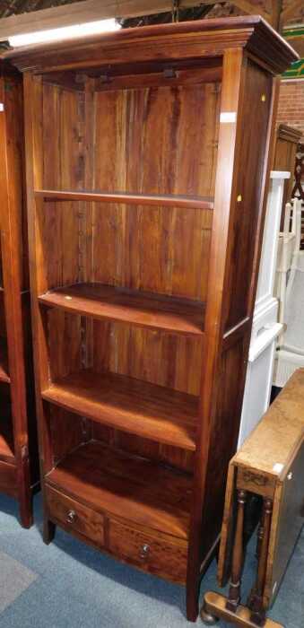 A modern bookcase, of four shelves with two drawers below, raised on square feet, 191cm high,...
