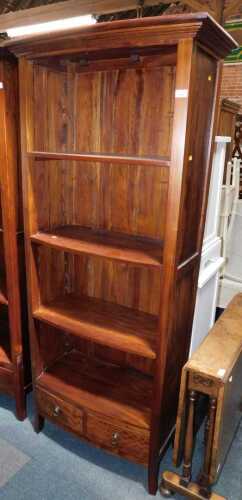 A modern bookcase, of four shelves with two drawers below, raised on square feet, 191cm high,...