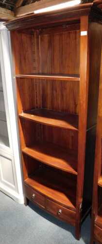 A modern bookcase, of four shelves with two drawers below, raised on square feet, 191cm high,...