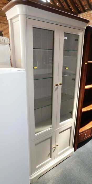 A contemporary grey finished display cabinet of two glazed doors with glass shelves to interior,...