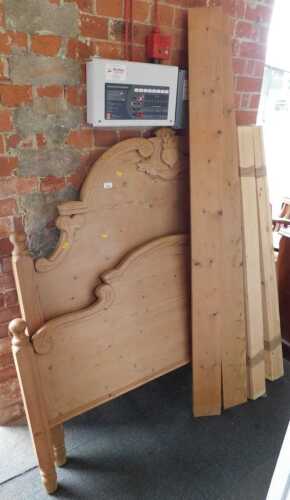 A late 20thC carved pine kingsize bed frame.