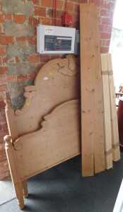 A late 20thC carved pine kingsize bed frame.