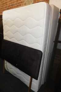 A double divan bed, with drawers to the base, mattress and headboard.