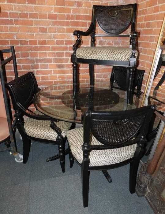 A dining suite, comprising a set of four ebonised dining chairs, two carvers, and two singles,...