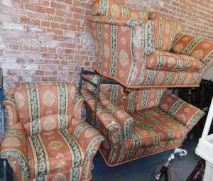 A three-piece suite, comprising two two-seater sofas, upholstered in a striped fabric with...