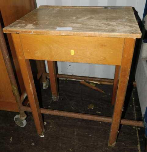 A beech child's school desk, with inkwell slot.