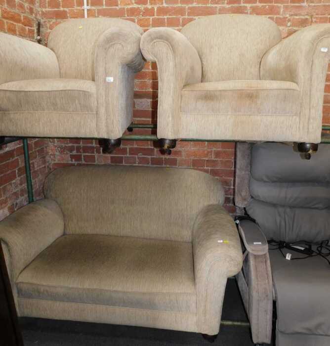 An early 20thC three piece suite, comprising two-seater drop arm sofa, and two open armchairs,...