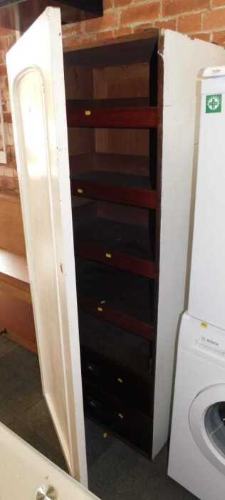 A section of a Victorian mahogany wardrobe, enclosing two drawers below four slides, later...