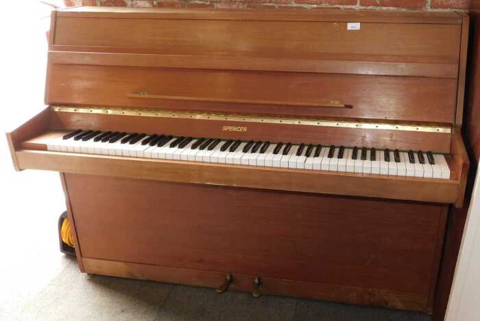 A Wakefield Spencer iron-framed upright piano, with traditional acoustic action and faux ivory...